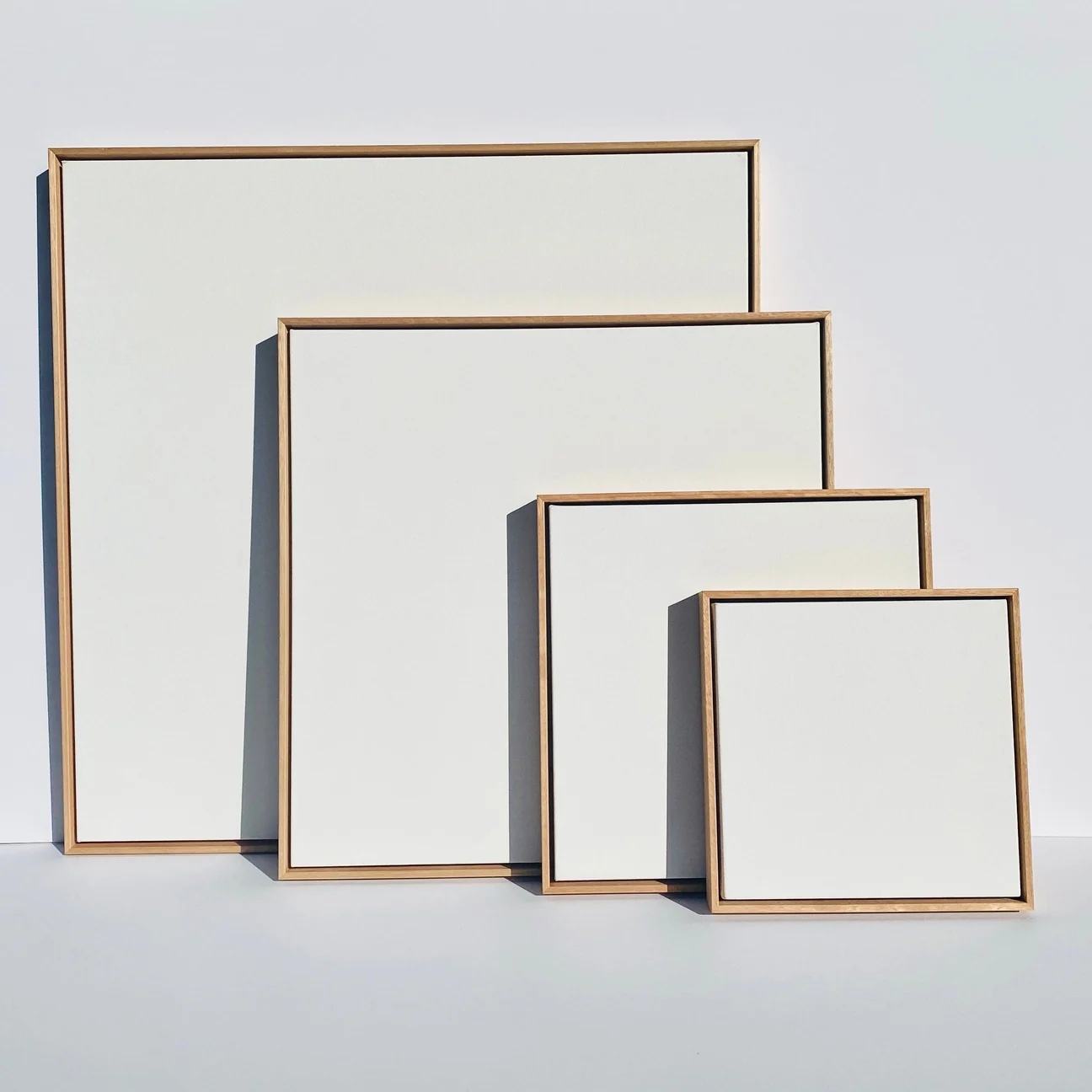 A selection of custom canvases in natural timber float frames